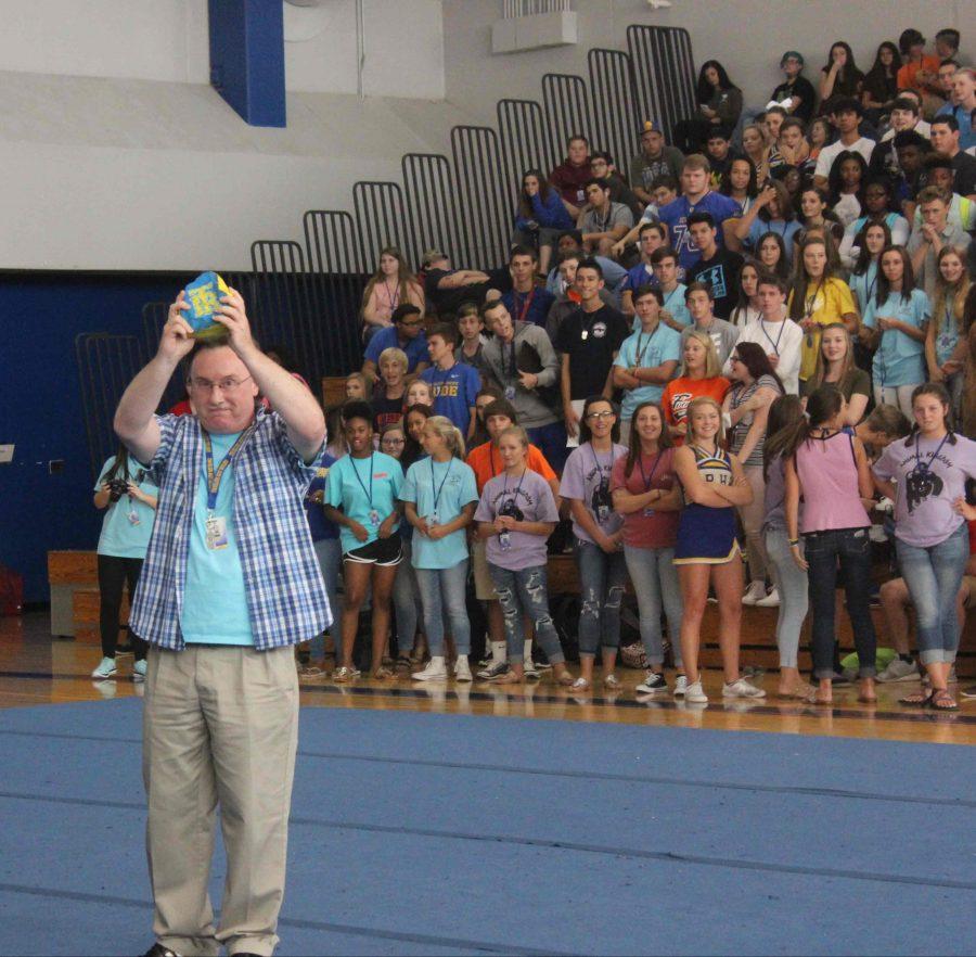 Mr. Nolen holding up the spirit rock at the pep rally