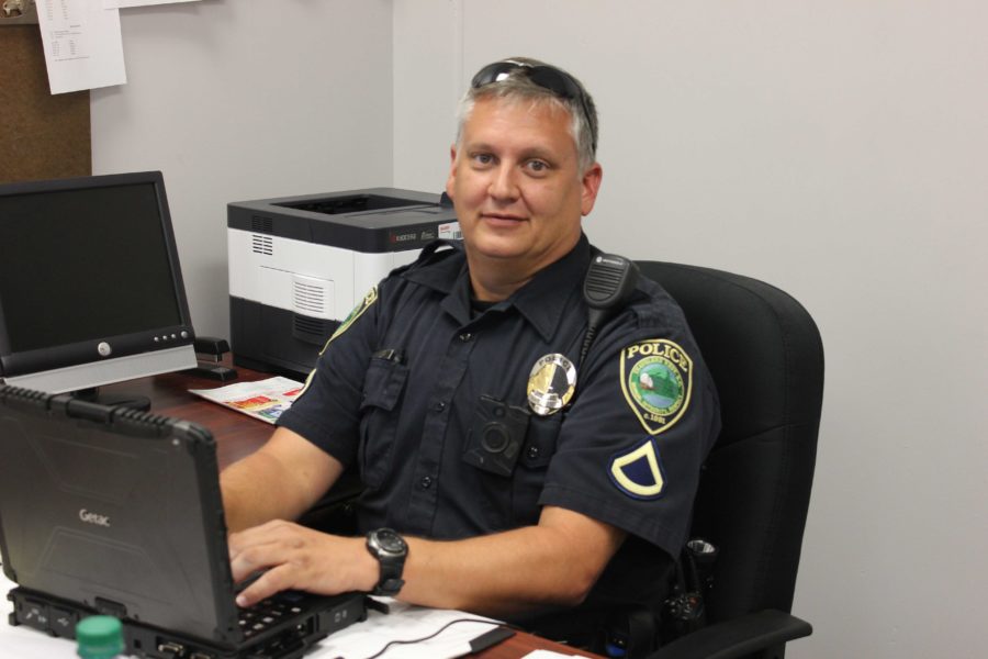 Officer Alsip sitting at his desk