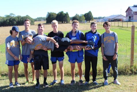 TRHS boys Cross Country Team hold up Coach King