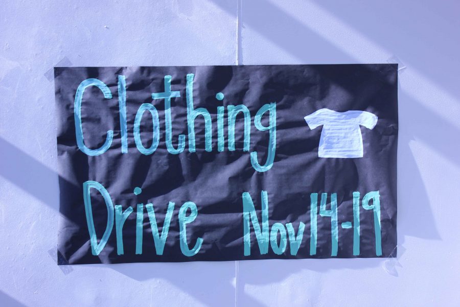 Student Council posts banners to advertise the clothing drive.