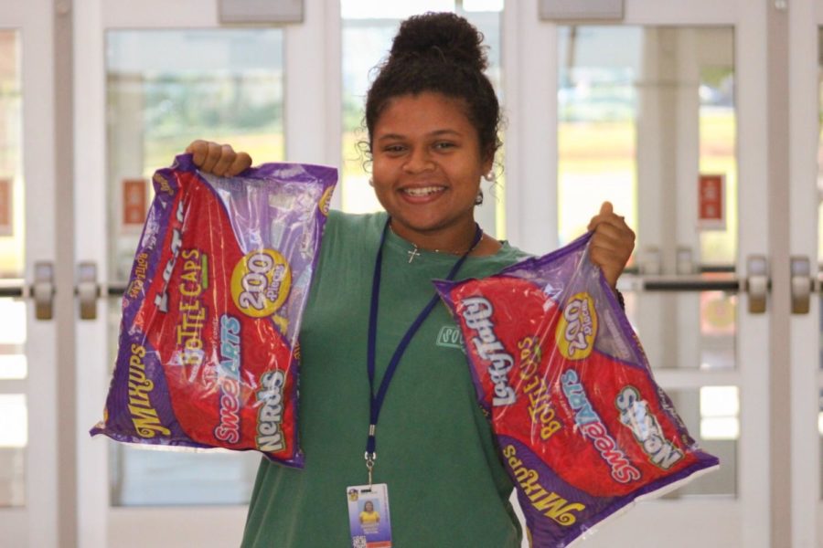 Sophomore+Barrett+Moody+posing+with+candy+bags+to+be+donated